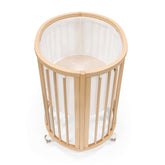 Stokke Sleepi Mini Mesh Liner V3 white closeup showing breathable fabric for safe sleep.