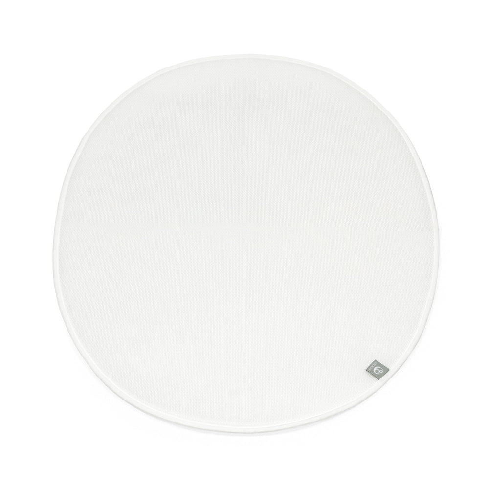 Stokke Sleepi Mini Protection Sheet V3 in white on bed, keeping the sleep surface clean.