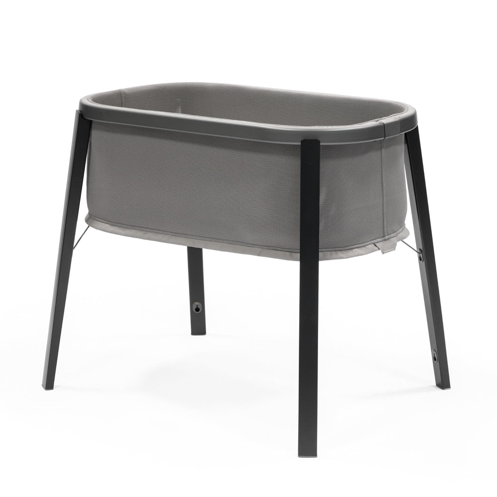 Stokke Snoozi Bassinet Graphite Grey profile view showing safe sleep surface.
