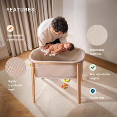 Stokke Snoozi Bassinet side view highlights height adjustment for growing babies.