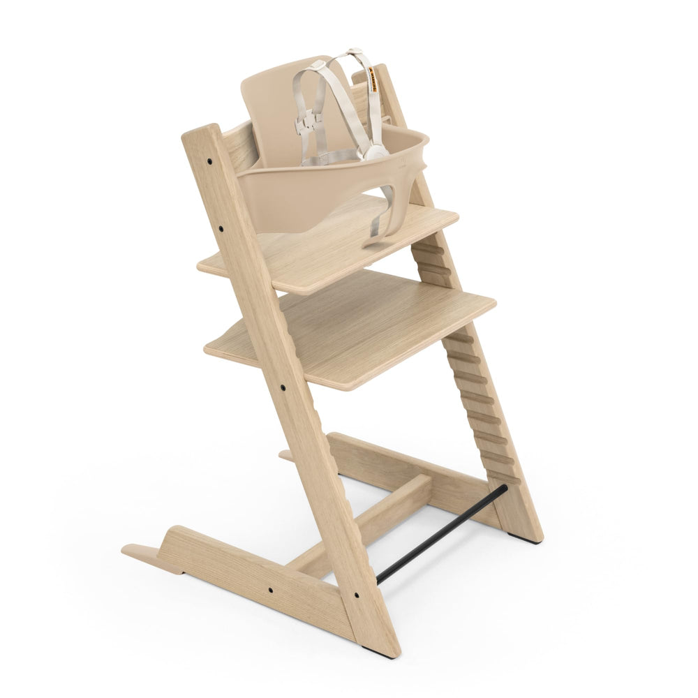 Stokke Tripp Trapp Oak High Chair 2 at table height for shared meals.