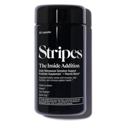 Stripes Beauty Naomi Watts Addition bottle on desk for daily probiotic support and wellness.