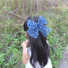 Sugarmelon large tulle bow hair clip closeup texture highlighting gauze and shimmer