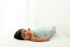 Swaddelini packaging blue colorway suggests ready-to-use newborn sleep solution.