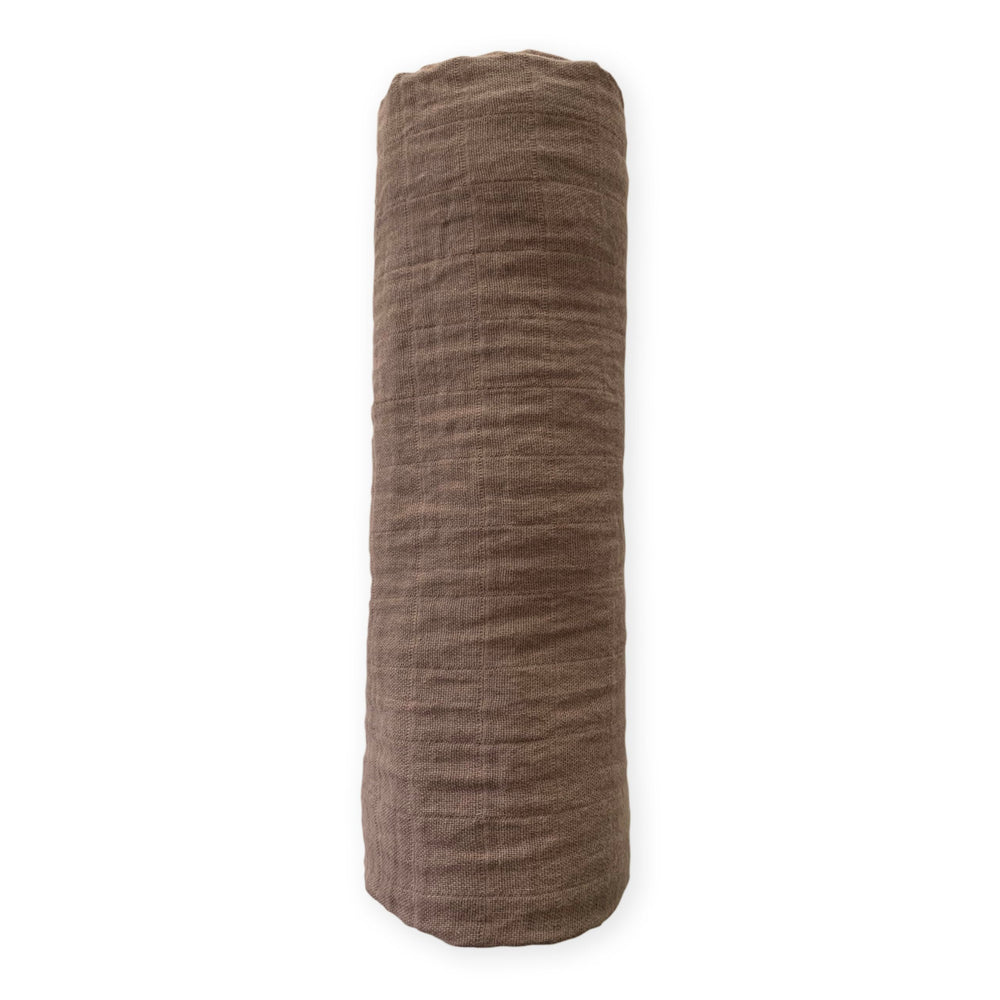 SwaddleDesigns cotton muslin swaddle blanket offers soft, breathable comfort.