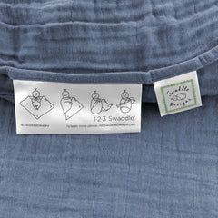 SwaddleDesigns denim muslin swaddle blanket with easy swaddle label.