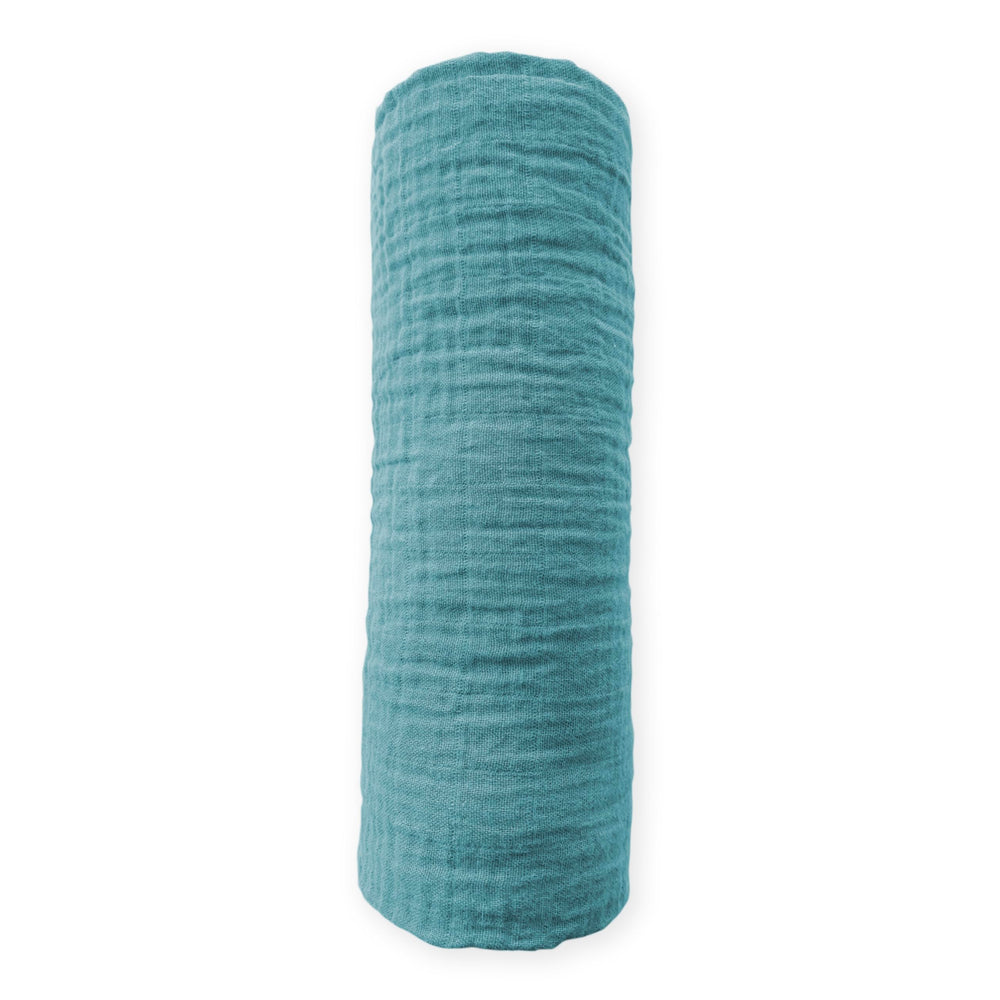 SwaddleDesigns teal cotton muslin blanket folded to show soft texture and premium color