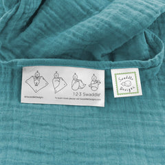SwaddleDesigns teal cotton muslin blanket draped as sunshield on a stroller