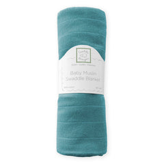 SwaddleDesigns teal muslin blanket swaddling a baby to highlight easy wrap steps