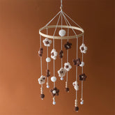 SWECOMZE baby mobile with colorful flowers gently rotates to soothe infant.