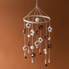 SWECOMZE baby mobile with colorful flowers gently rotates to soothe infant.