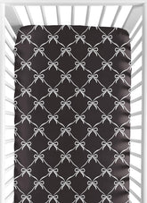 Sweet Jojo Designs fitted crib sheet with black and white bows creates a cozy sleep space.