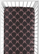 Sweet Jojo Designs fitted crib sheet with black and pink bows for a snug fit.