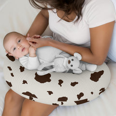 Sweet Jojo Designs muslin pillow cover on a bed with western cow print coordinating nursery decor.