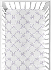 Sweet Jojo Designs purple bows fitted crib sheet showing snug fit for standard cribs.