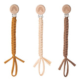 Symbolife pacifier clip close-up showing wooden teeth grip.