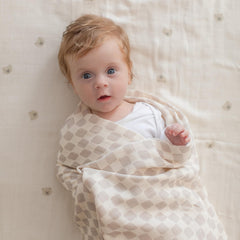 TAB Muslin Swaddle Blanket tan checkered pattern laid flat for versatile daily use.