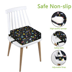Close-up of Taeku booster seat with two safety buckles securing it to a chair.