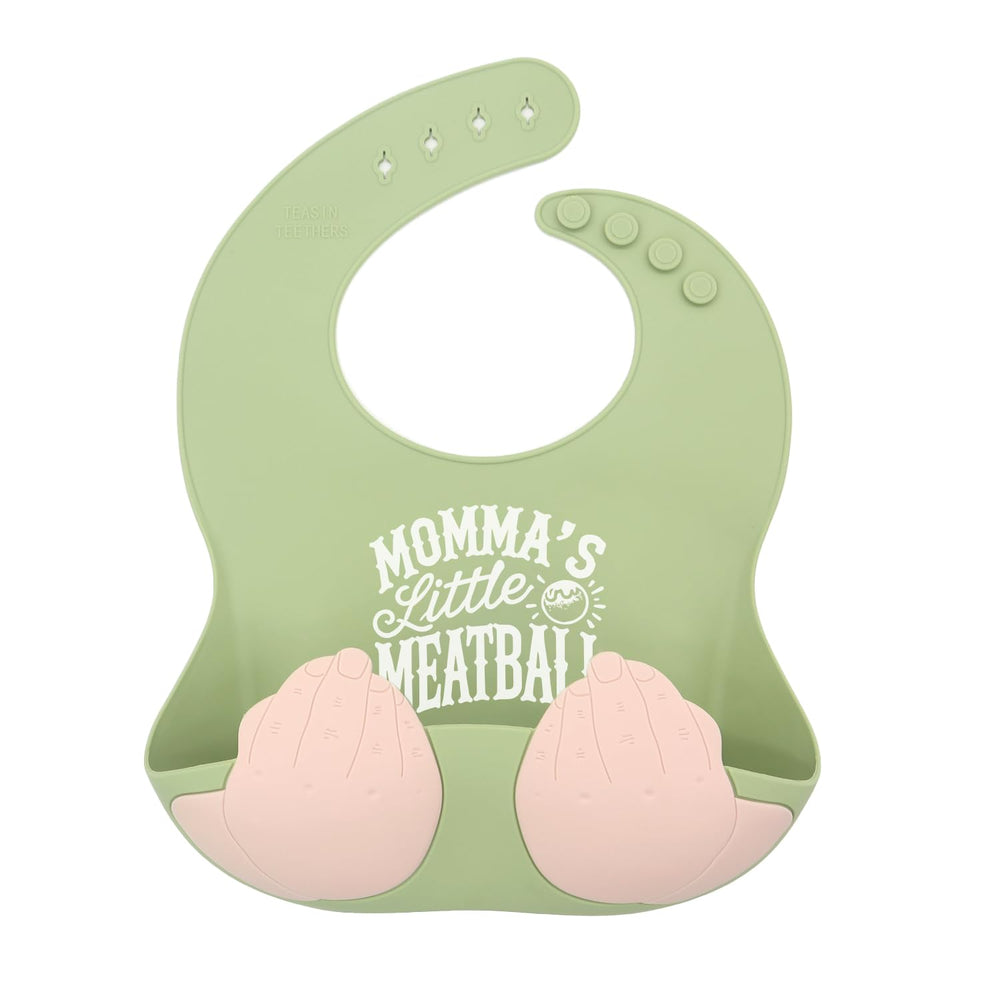 Teasin' Teethers Meatball Green bib with pocket catching spills during meals.