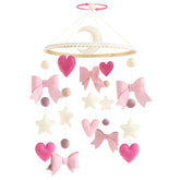 Teeloray pink bow cradle mobile enhances nursery decor and visual focus for newborns.