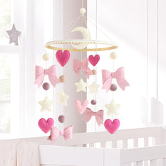 Teeloray pink bow moons stars design supports early visual development in baby's room.