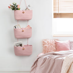 TeoKJ pink nursery organizer holds towels and diapers.