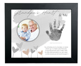 The Grandparent Gift Co. baby handprint frame for grandpa on wall preserves a cherished memory.