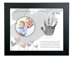The Grandparent Gift Co. baby handprint frame for grandpa on wall preserves a cherished memory.