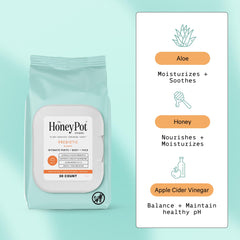 Prebiotic wipes bottle closeup showing fragrance-free formula for sensitive areas.