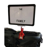 The Uncommon Reserve Stroller Scout clip-on sign attached to a stroller handle for quick spotting.
