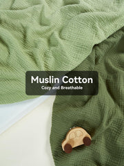TILLYOU light green muslin crib sheet close-up shows gentle fabric and snug fit