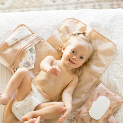 Tiny Twinkle changing pad with organized pockets for diapers and creams