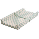 Tiny Twinkle Sage Checkers cover on changing pad for mess-proof diaper changes