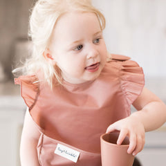Tiny Twinkle Mess-Proof Bib uses waterproof fabric to repel spills at mealtime.