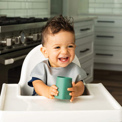 Tiny Twinkle grey open-cup training cup with parent guidance.