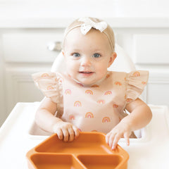 Tiny Twinkle waterproof baby apron in action during messy feeding sessions.