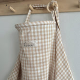 TISU nursing cover in beige gingham used for breastfeeding privacy and comfort
