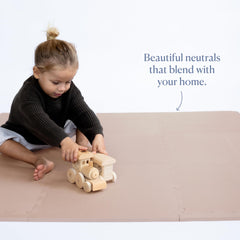 Toddlekind playmat being wiped clean demonstrates easy maintenance.