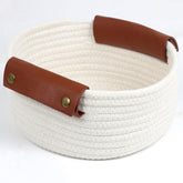 Togous small round basket with wide leather handle for easy transport.