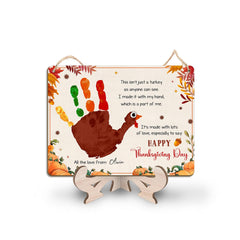 TRUMPETIC turkey handprint sign on craft display, perfect keepsake for a child's first Thanksgiving.