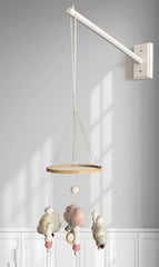 Tuiiopoli mobile wooden arm on crib, space-saving nursery solution.