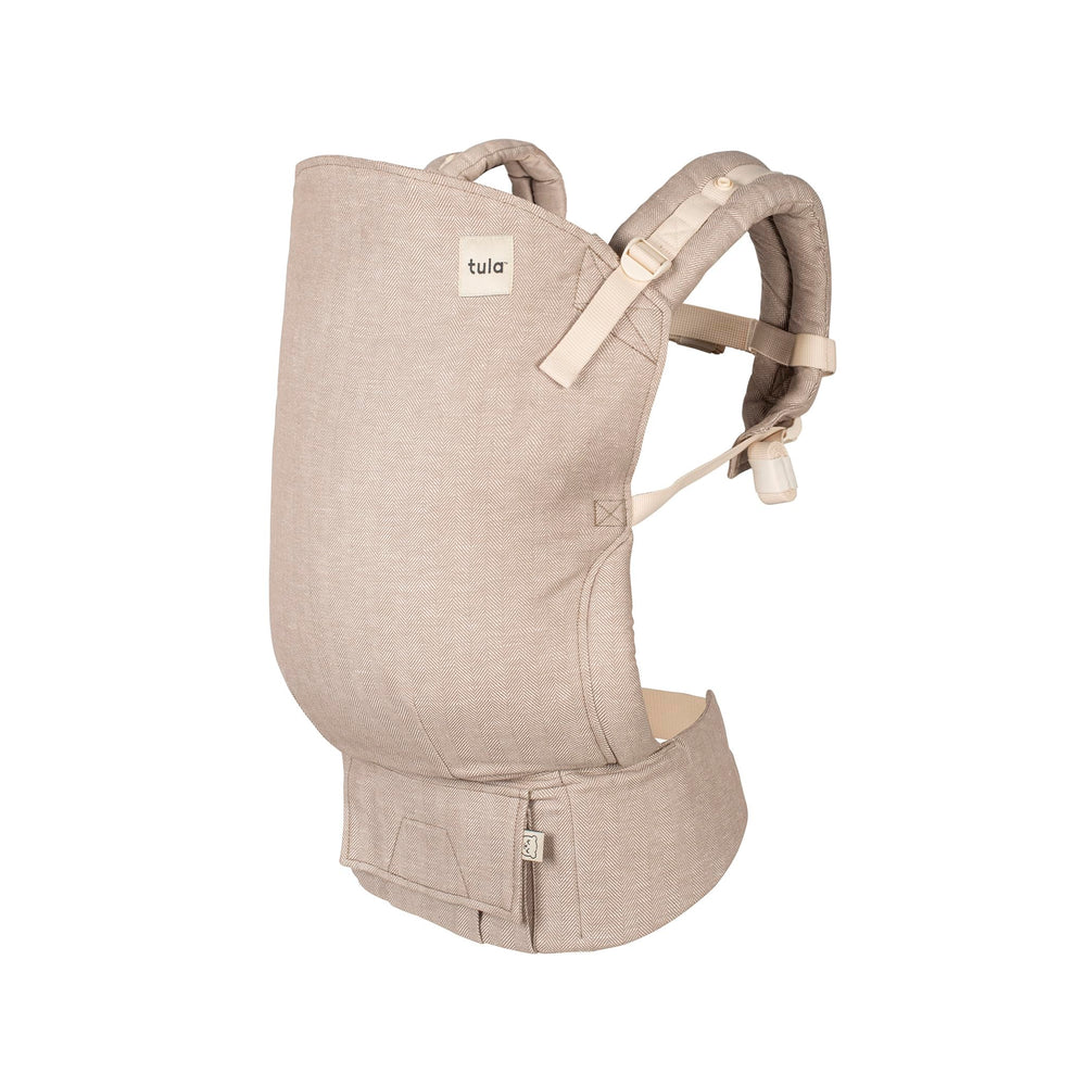 Tula Linen Toddler Carrier Sand — front view highlighting ergonomic seat and breathable fabric