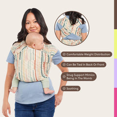 Tula Stretchy Tencel wrap worn by caregiver demonstrates ergonomic hands-free carry.