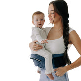 TushBaby hip seat carrier back view with ergonomic support for growing babies