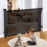 Uamector retractable gate extended across doorway for babies and small pets.