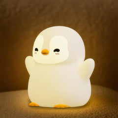 UNEEEDE standing penguin night light glows softly for bedtime routines.
