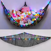 Unicorn Castle hammock with stuffed animals in a kid's room for tidy storage.