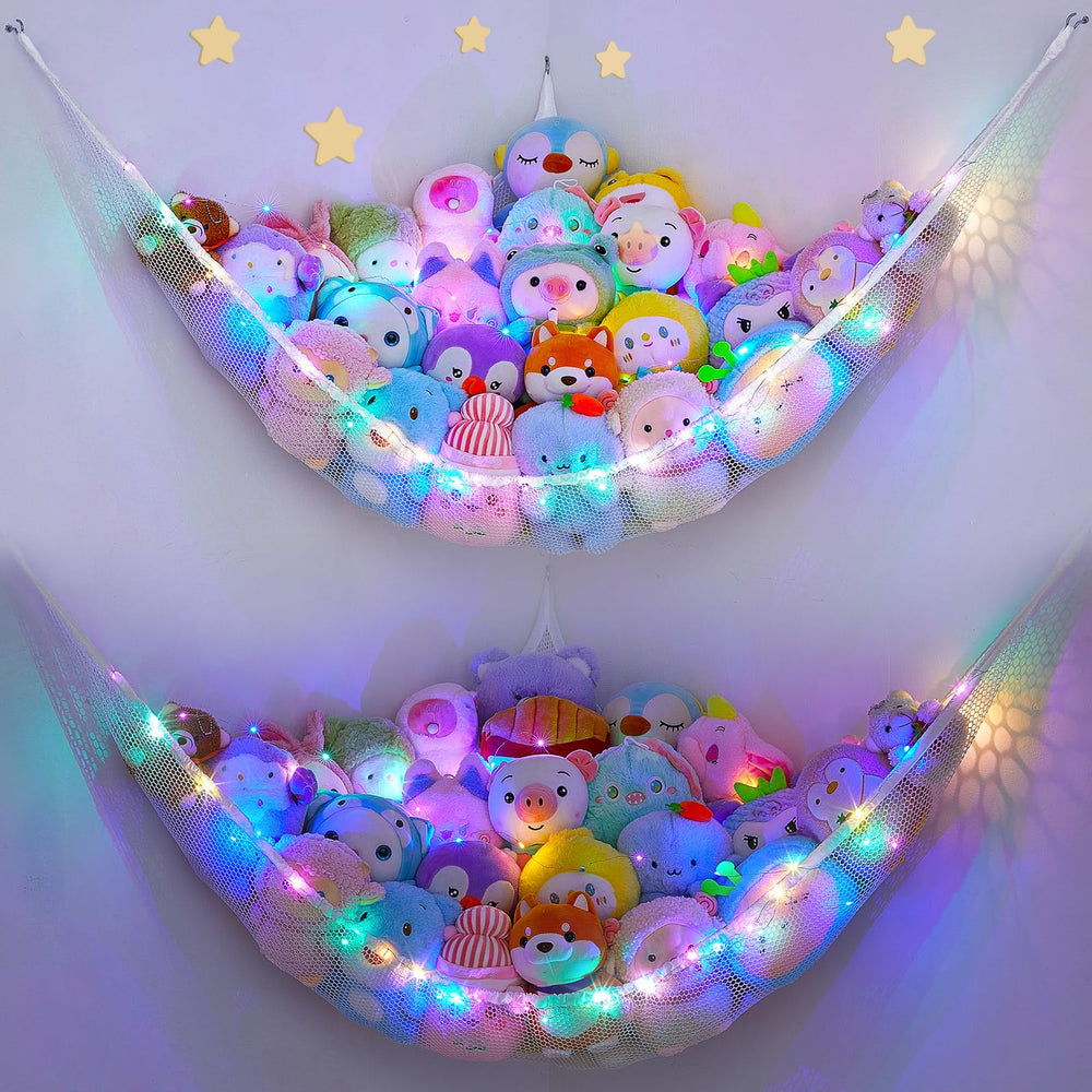 Unicorn Castle hammock with LED light holding stuffed animals in a bright kids' room.