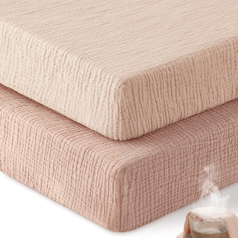 Unnivoll muslin crib sheet gradient pink close-up shows soft breathable cotton.