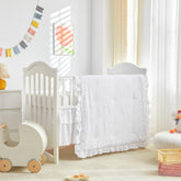 UOZZI BEDDING tufted ruffle crib comforter close-up showing soft, cozy texture